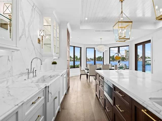 a living room with patio furniture and a large window
