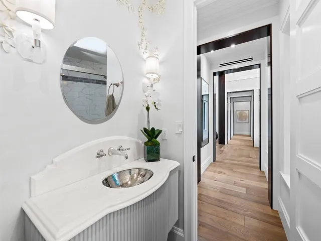 a bathroom with a granite countertop sink mirror and bathtub