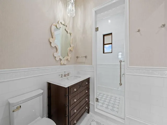 a room with a bed tv and cabinets