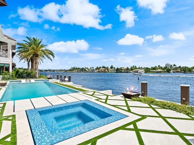 a spacious bedroom with a large bed couch and a large window