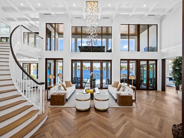 a view of a living room with balcony furniture and a large window