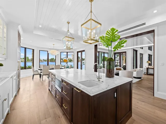 a living room with patio furniture and a large window