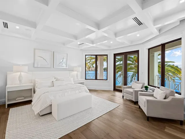 a view of a dining room with furniture a chandelier and wooden floor