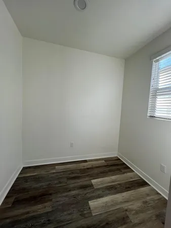 a view of wooden floor and cabinet in a room