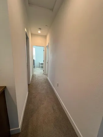 a view of a hallway with wooden floor
