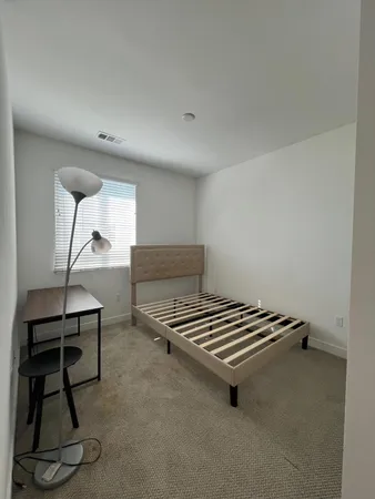 a room with gym equipment and wooden floor