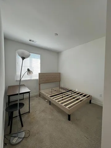 a room with gym equipment and wooden floor