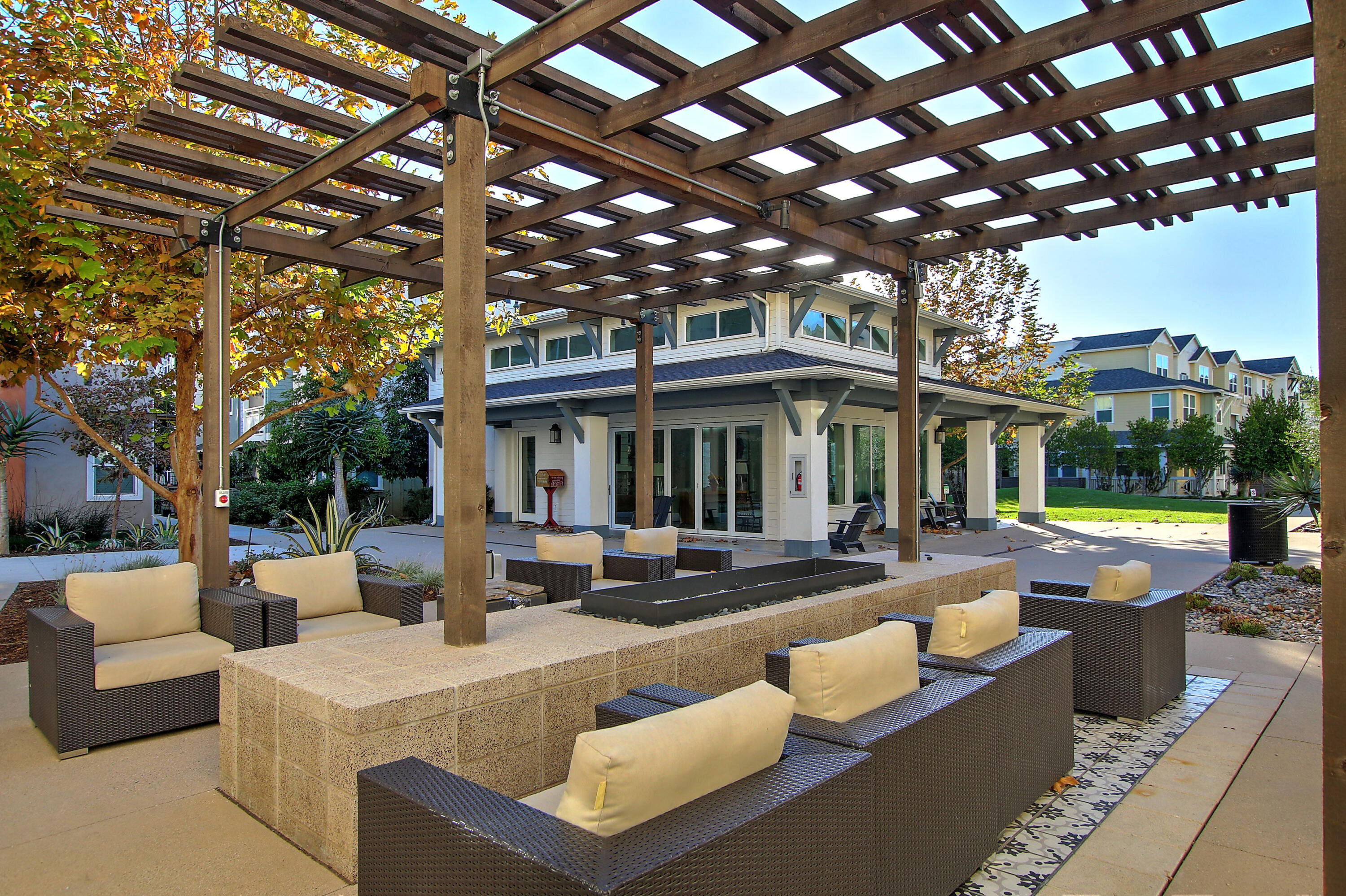 519 Bolinas Way, Unit 104 Goleta, CA 93117 - Photo 4 of 22 a view of a patio with couches table and chairs with a large tree