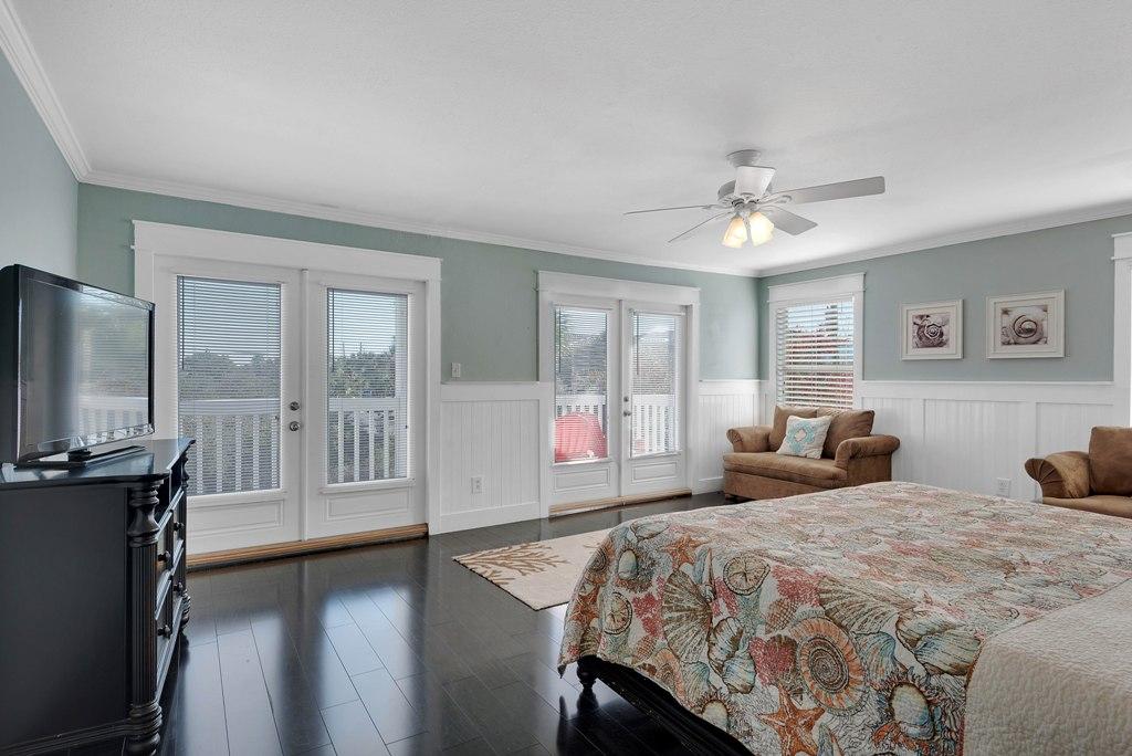 68 Cobia Street Destin, FL 32541 - Photo 14 of 47 a bedroom with a balcony a bed and a flat screen tv