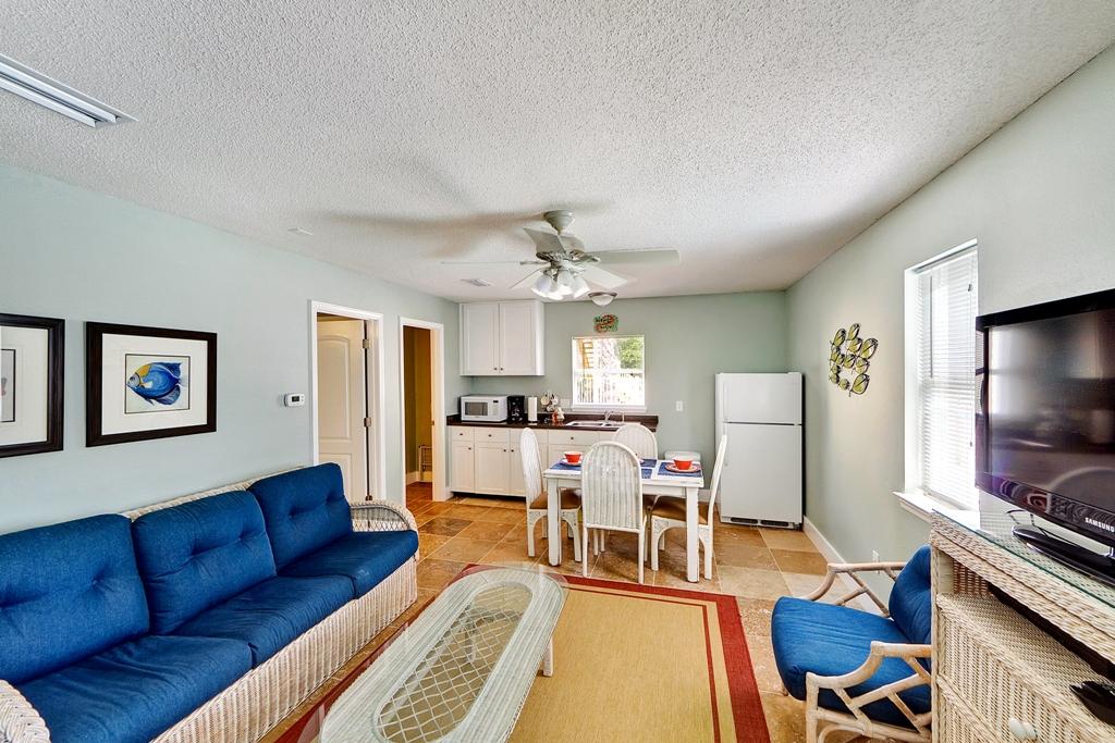 68 Cobia Street Destin, FL 32541 - Photo 22 of 47 a living room with furniture a flat screen tv and kitchen view