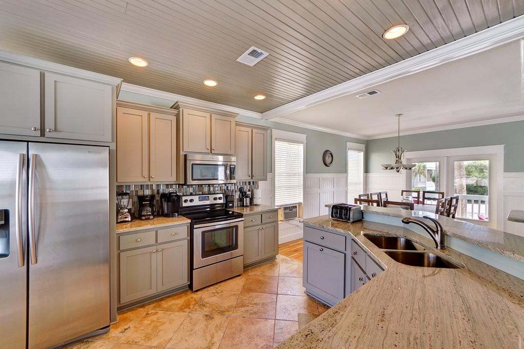 68 Cobia Street Destin, FL 32541 - Photo 26 of 47 a kitchen with sink refrigerator and stove