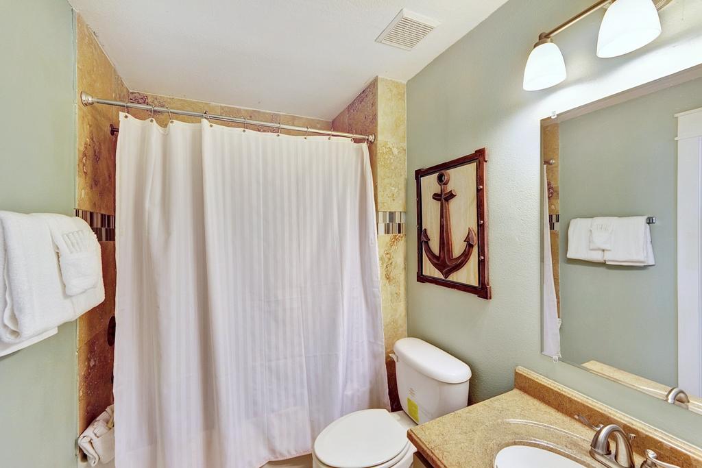 68 Cobia Street Destin, FL 32541 - Photo 37 of 47 a white toilet sitting next to a bathroom sink