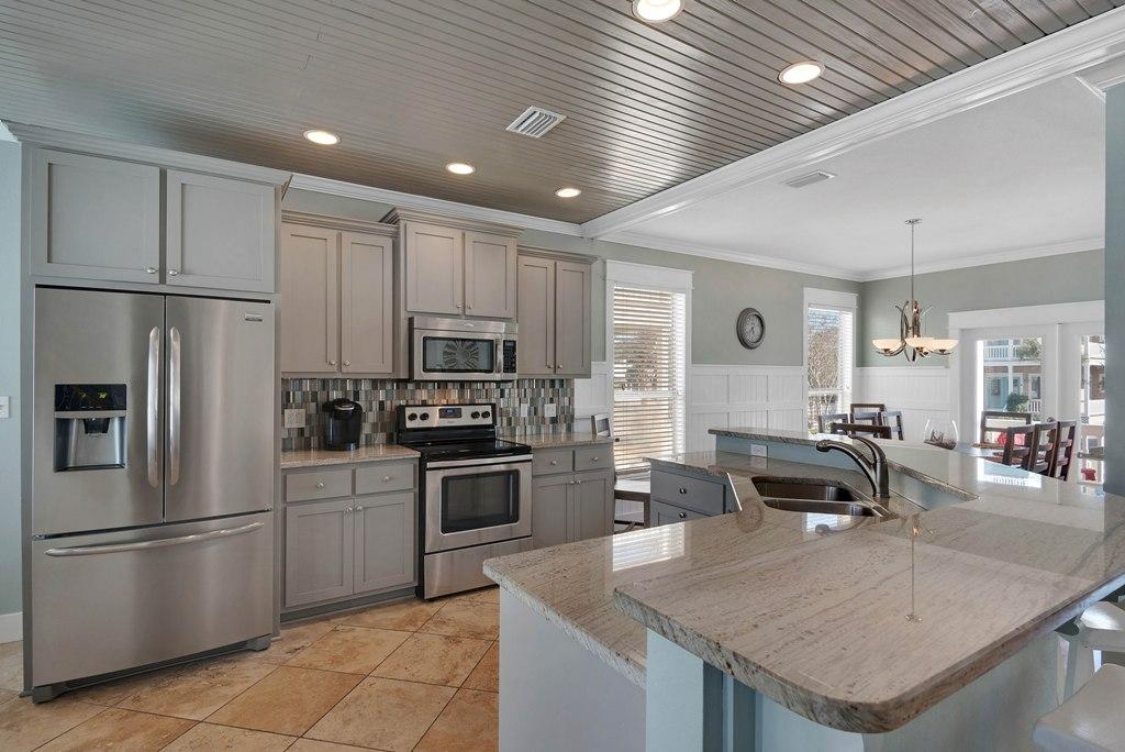 68 Cobia Street Destin, FL 32541 - Photo 7 of 47 a kitchen with stainless steel appliances granite countertop a sink a stove and a refrigerator