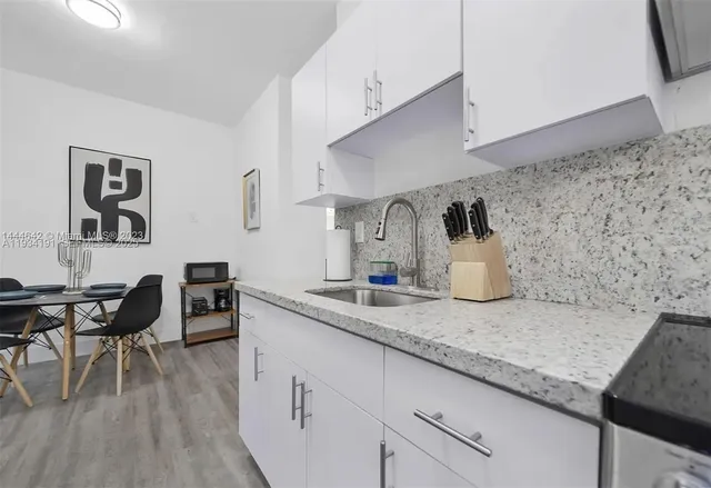 a kitchen with sink and cabinets
