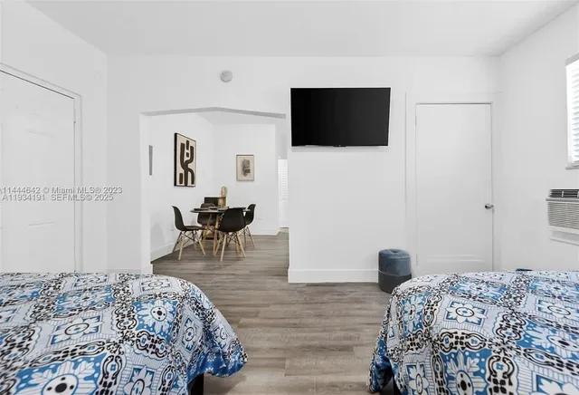 a bedroom with a bed and a flat screen tv