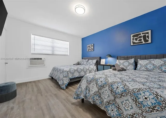 a bedroom with two beds and painted walls