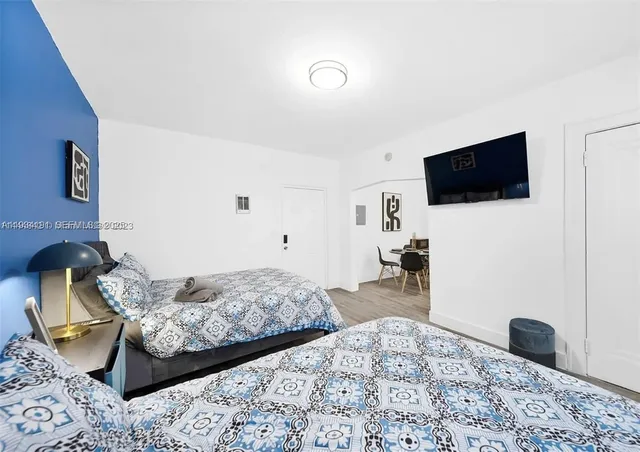 a bedroom with a bed and a television