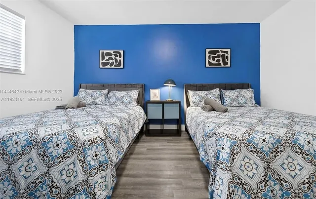 a bedroom with bed and painting on the wall