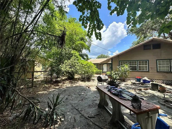 a backyard of a house with table and chairs