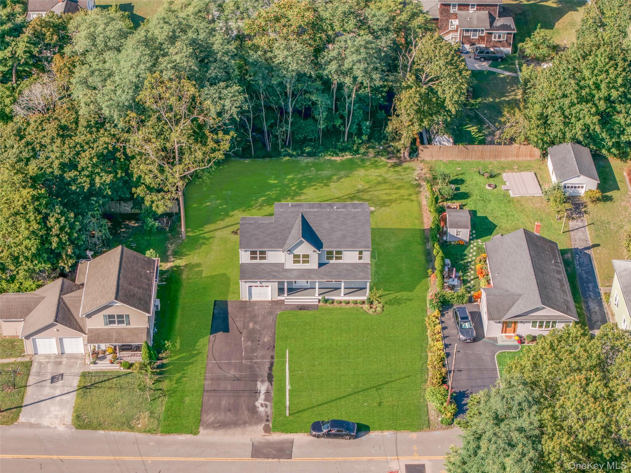 817 Pond View Road Riverhead, NY 11901 - Photo 11 of 36 an aerial view of a house with garden space and street view