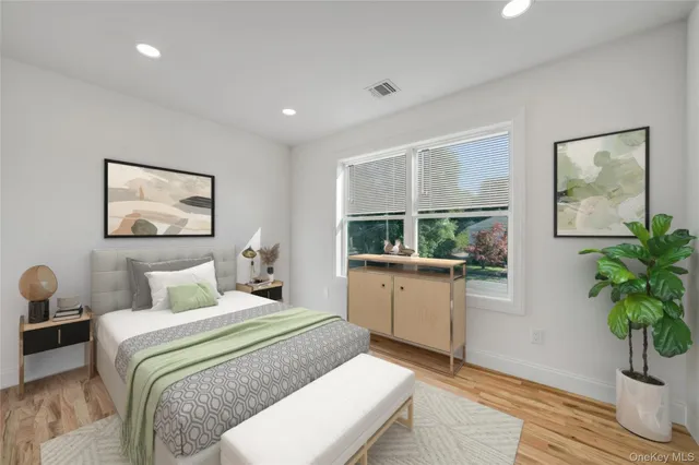 a bedroom with a bed and a potted plant