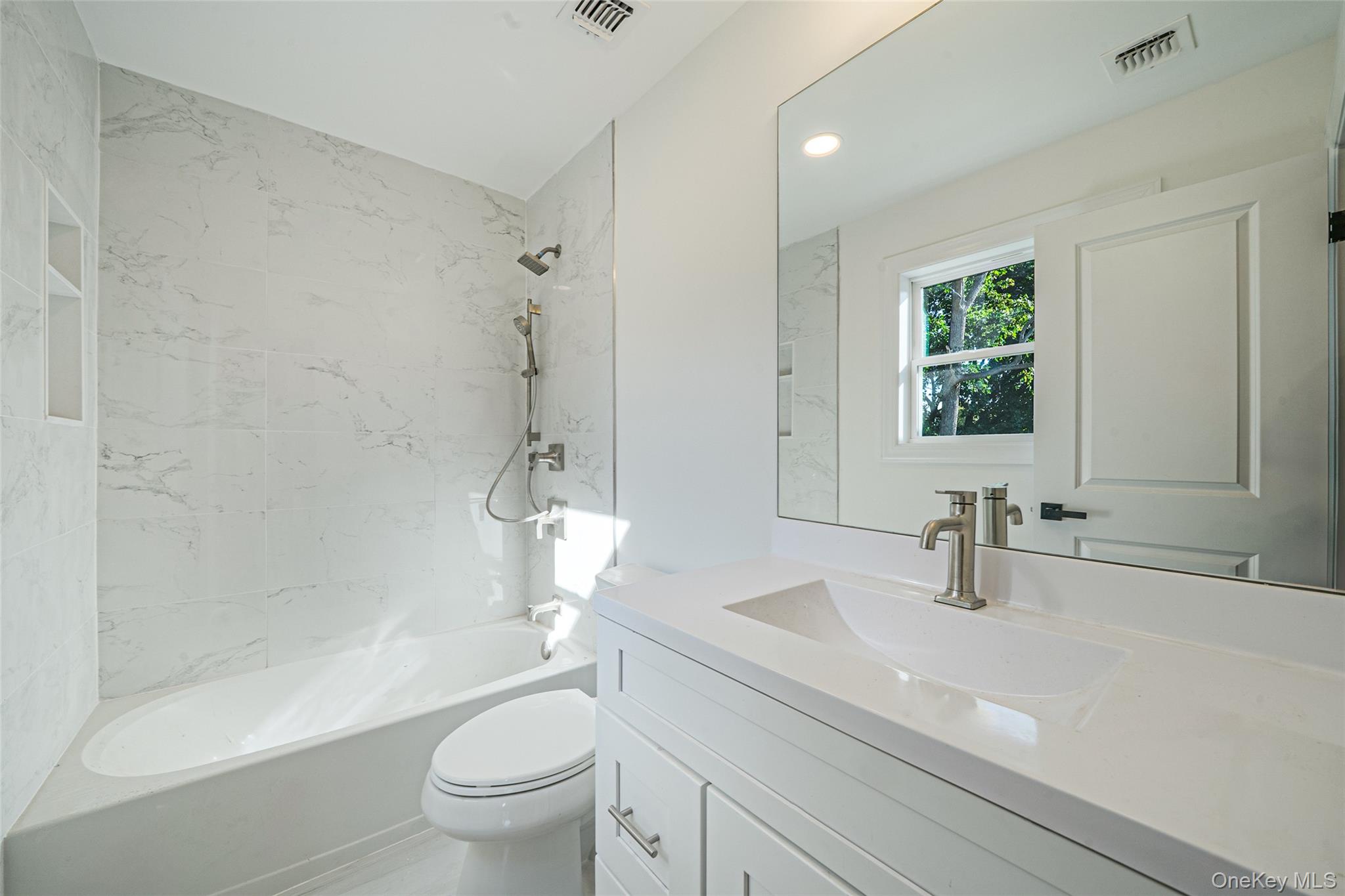 817 Pond View Road Riverhead, NY 11901 - Photo 29 of 36 a bathroom with a sink a toilet and a large mirror