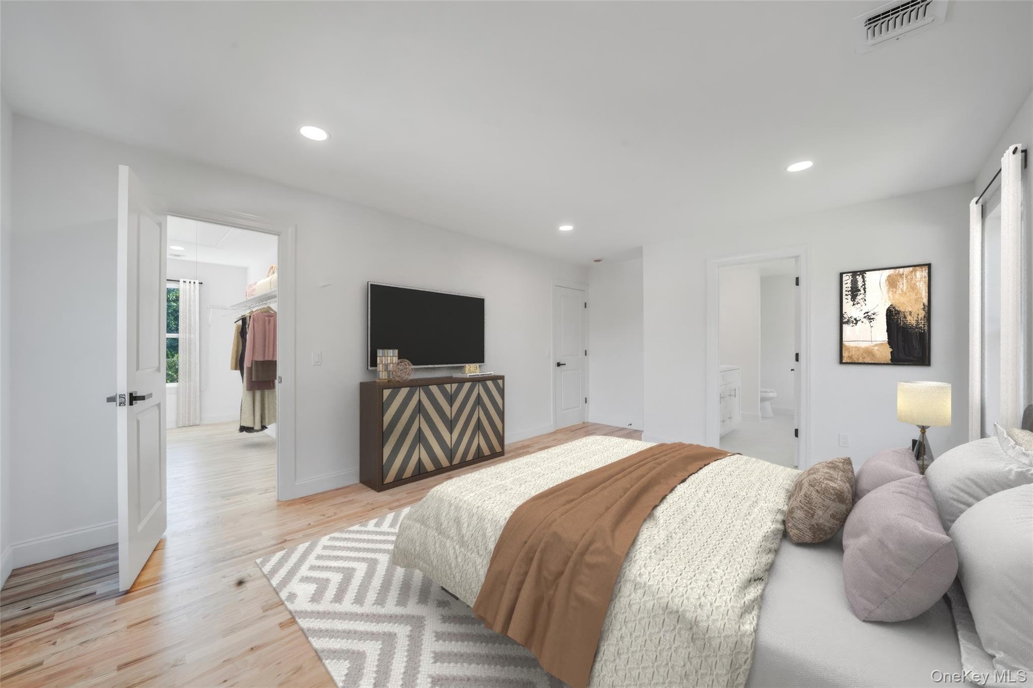 817 Pond View Road Riverhead, NY 11901 - Photo 30 of 36 a bedroom with a bed and a television