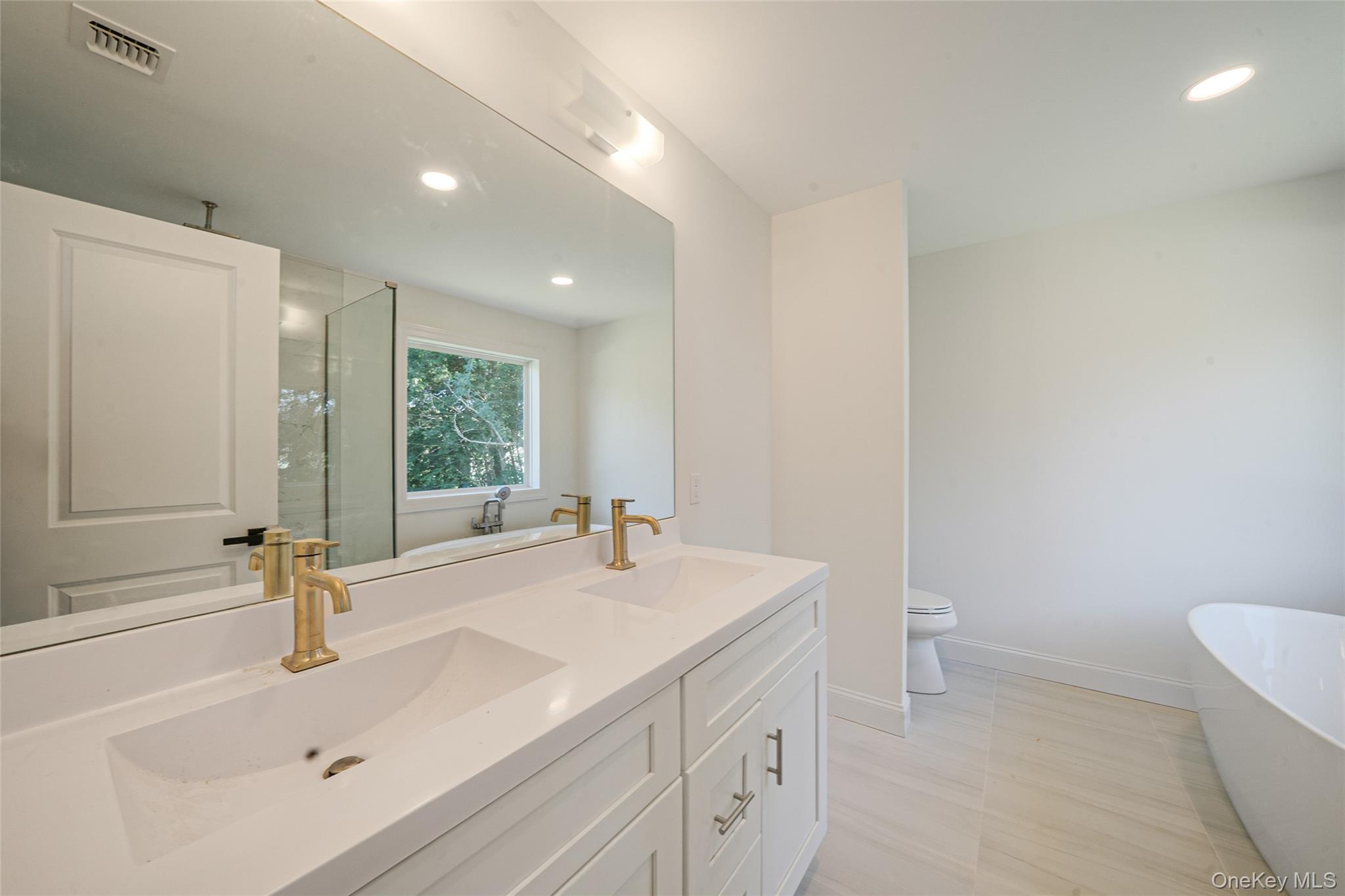 817 Pond View Road Riverhead, NY 11901 - Photo 31 of 36 a bathroom with a sink and a toilet