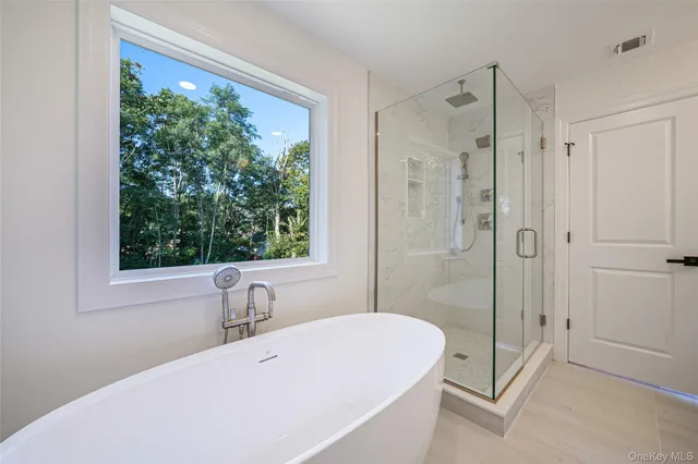 a bathroom with a double vanity sink mirror and shower
