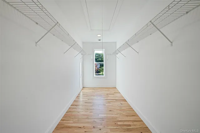 a view of an empty room with cabinet and stairs