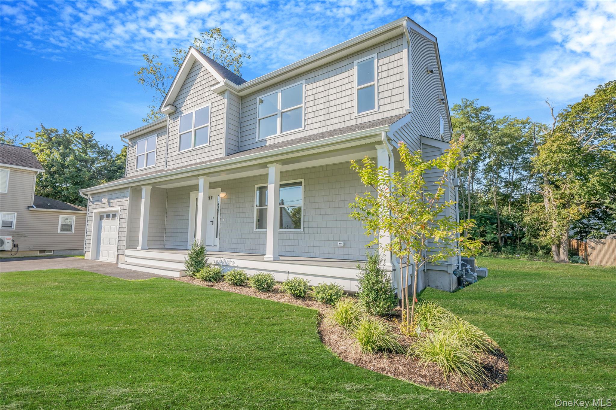 817 Pond View Road Riverhead, NY 11901 - Photo 4 of 36 a front view of a house with a yard table and chairs