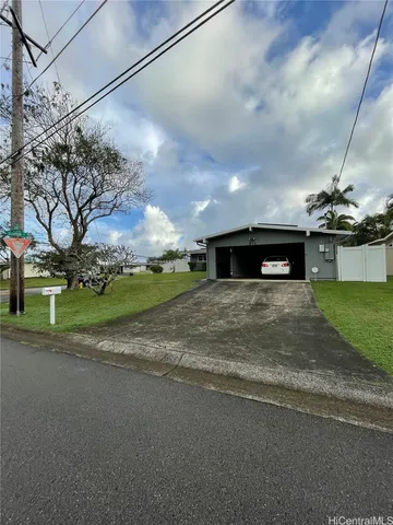 a view of a big yard with large trees