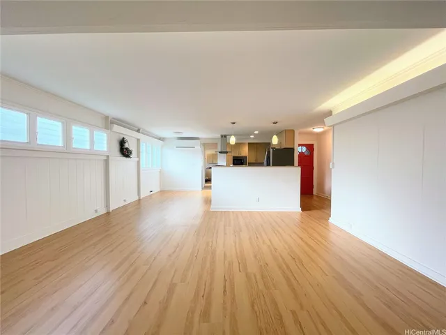 a view of a kitchen with wooden floor and a sink