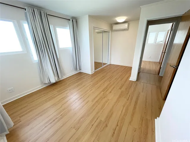 a view of a room with wooden floor and staircase