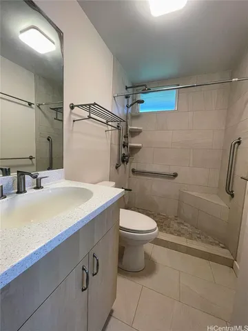 a bathroom with a sink a toilet and shower