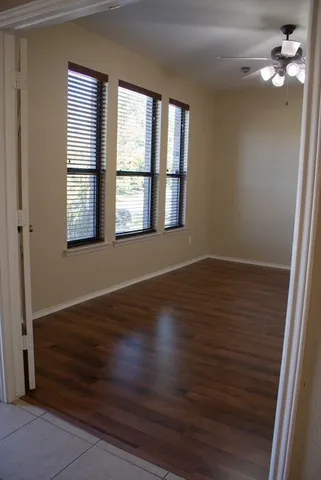 wooden floor in an empty room with a window