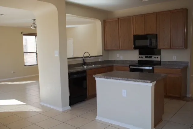 a kitchen with a sink and a stove top oven