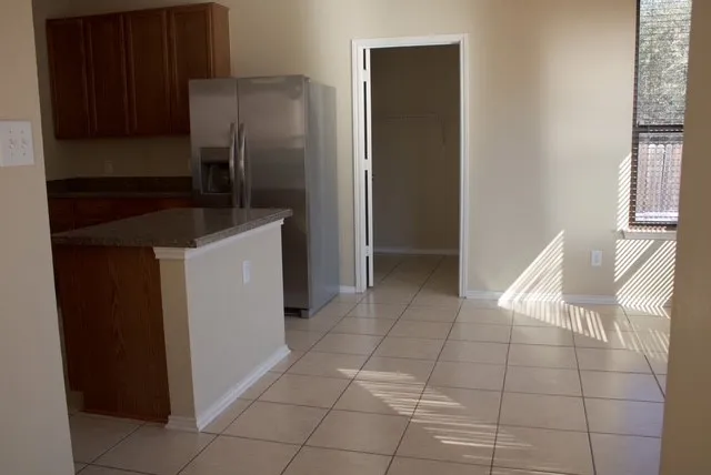 a kitchen with a refrigerator and cabinets