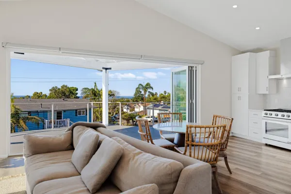 a living room with furniture and a floor to ceiling window