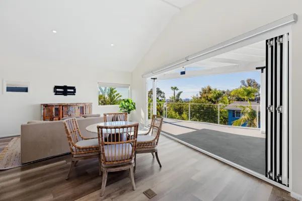a dining room with furniture and a floor to ceiling window