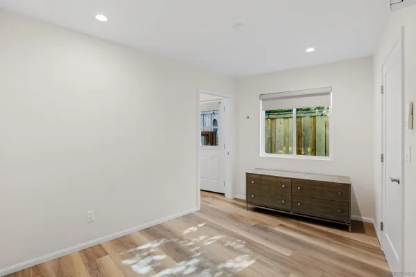 a view of wooden floor and entryway in a room