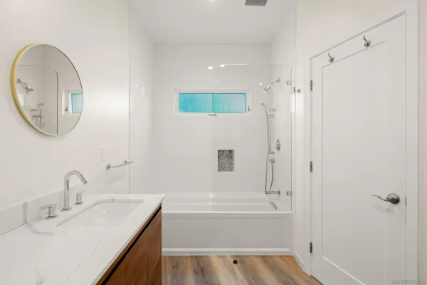 a bathroom with a sink a toilet and a mirror