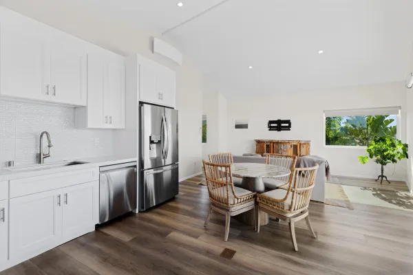 a view of a kitchen with a dining table and chairs