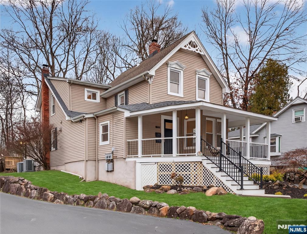 114 Colony Avenue, Unit 2 Park Ridge, NJ 07656 - Photo 11 of 12 a front view of a house with a garden and trees