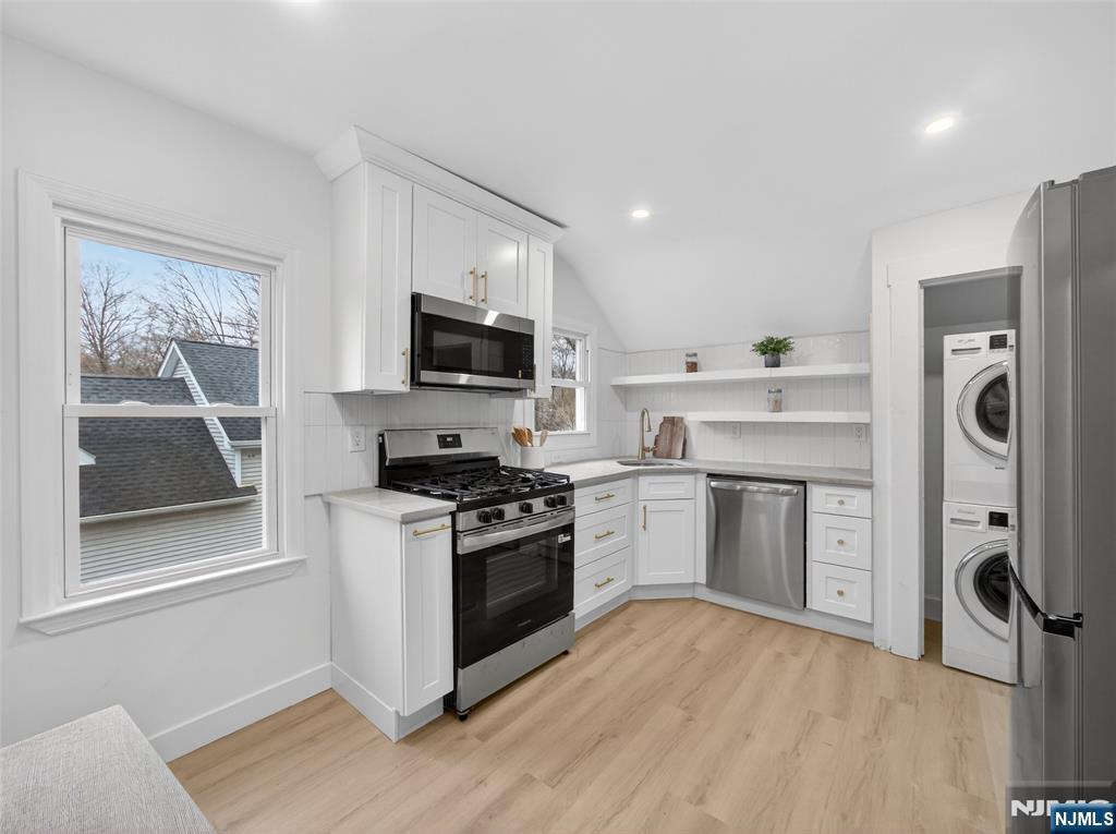 114 Colony Avenue, Unit 2 Park Ridge, NJ 07656 - Photo 4 of 12 a kitchen with a stove a sink and a microwave