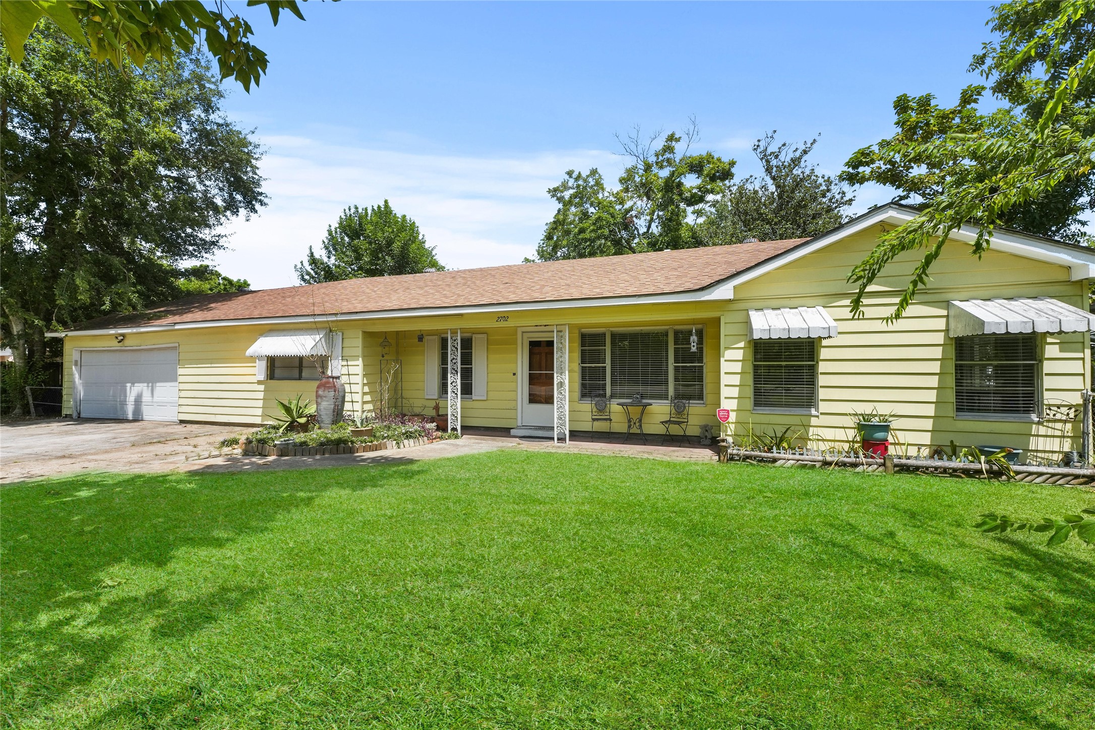 a view of a house with a yard and sitting area