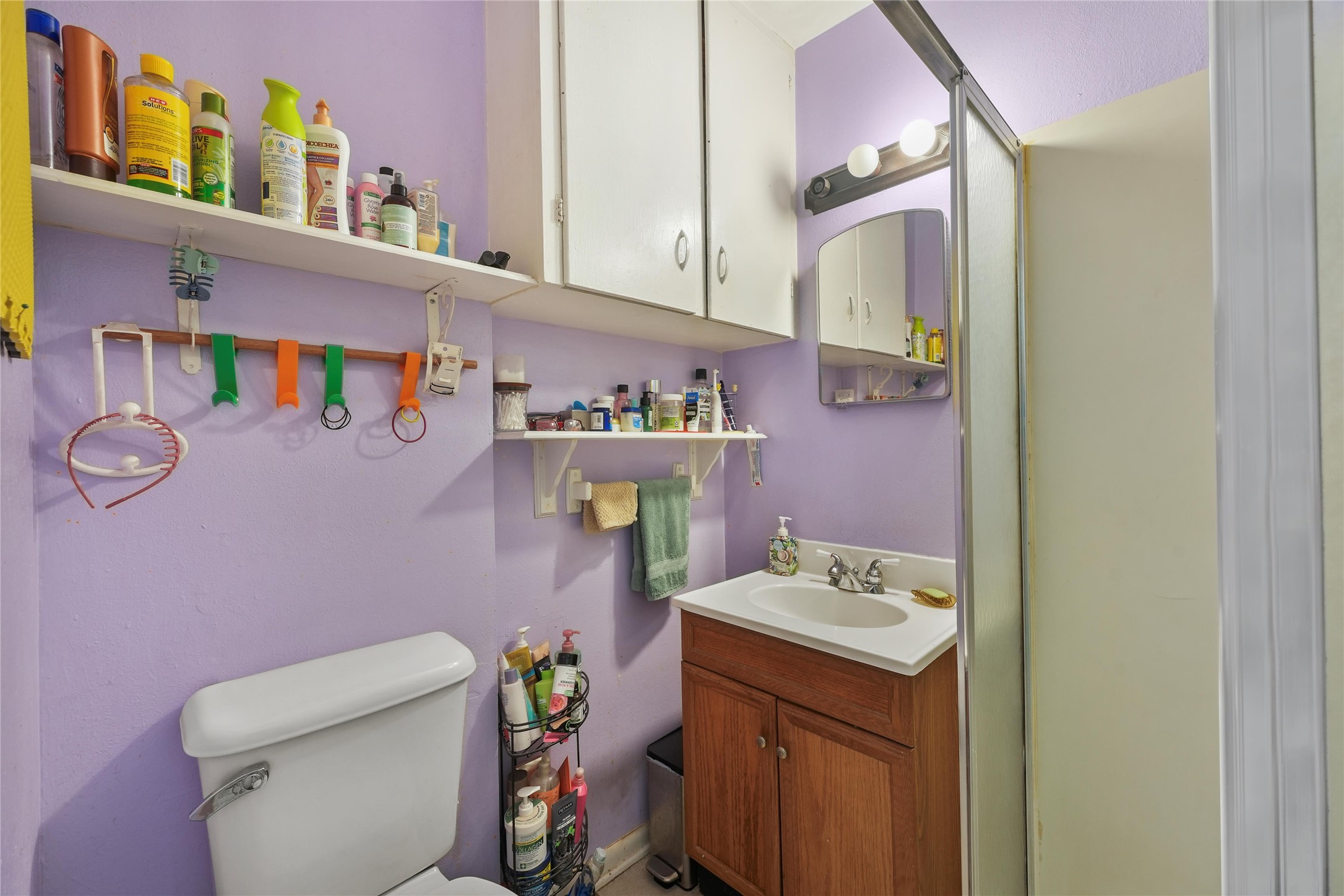 2702 Mckinney Road Baytown, TX 77520 - Photo 20 of 22 a bathroom with a sink a toilet and a mirror