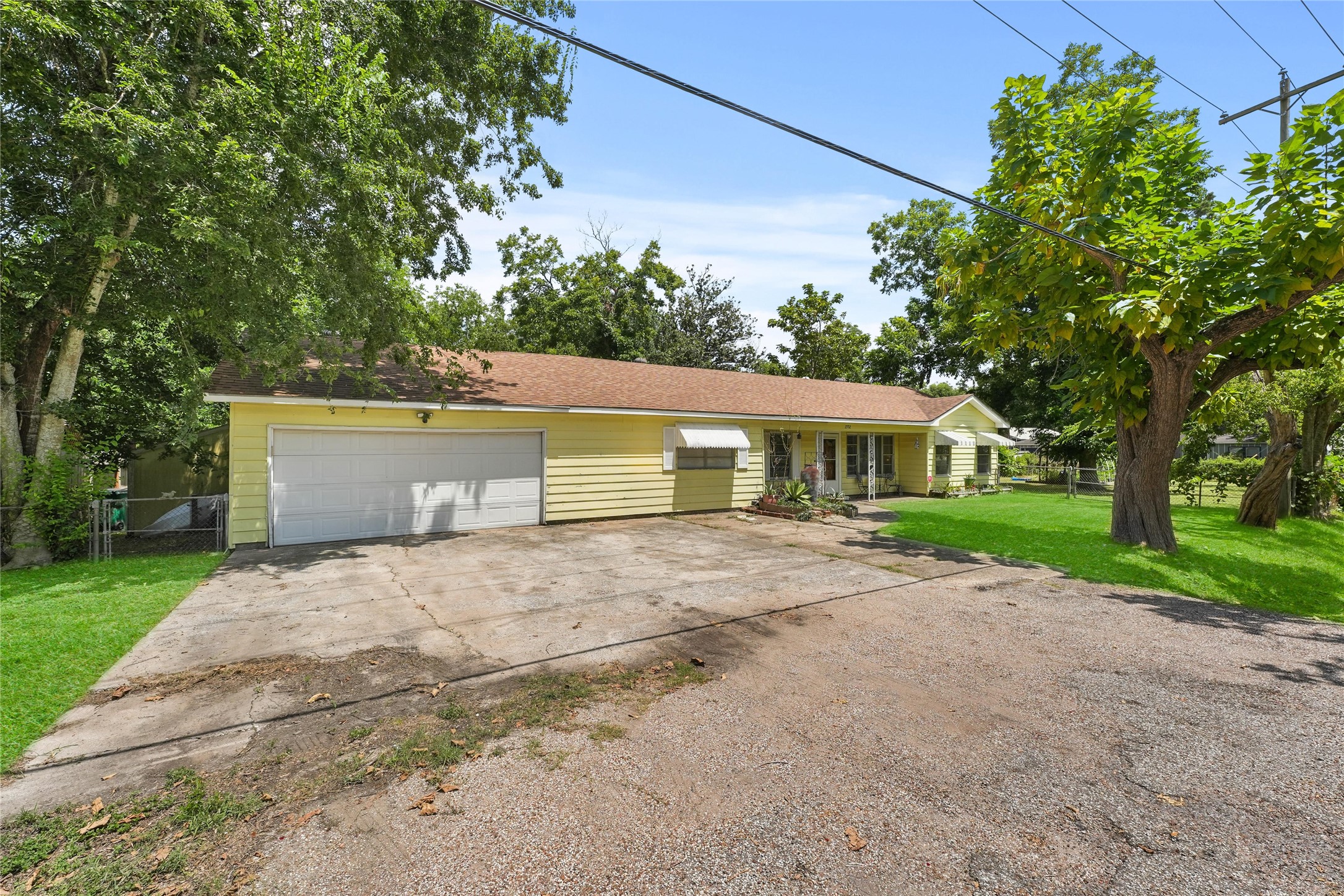 2702 Mckinney Road Baytown, TX 77520 - Photo 2 of 22 a view of a house with a yard and large tree