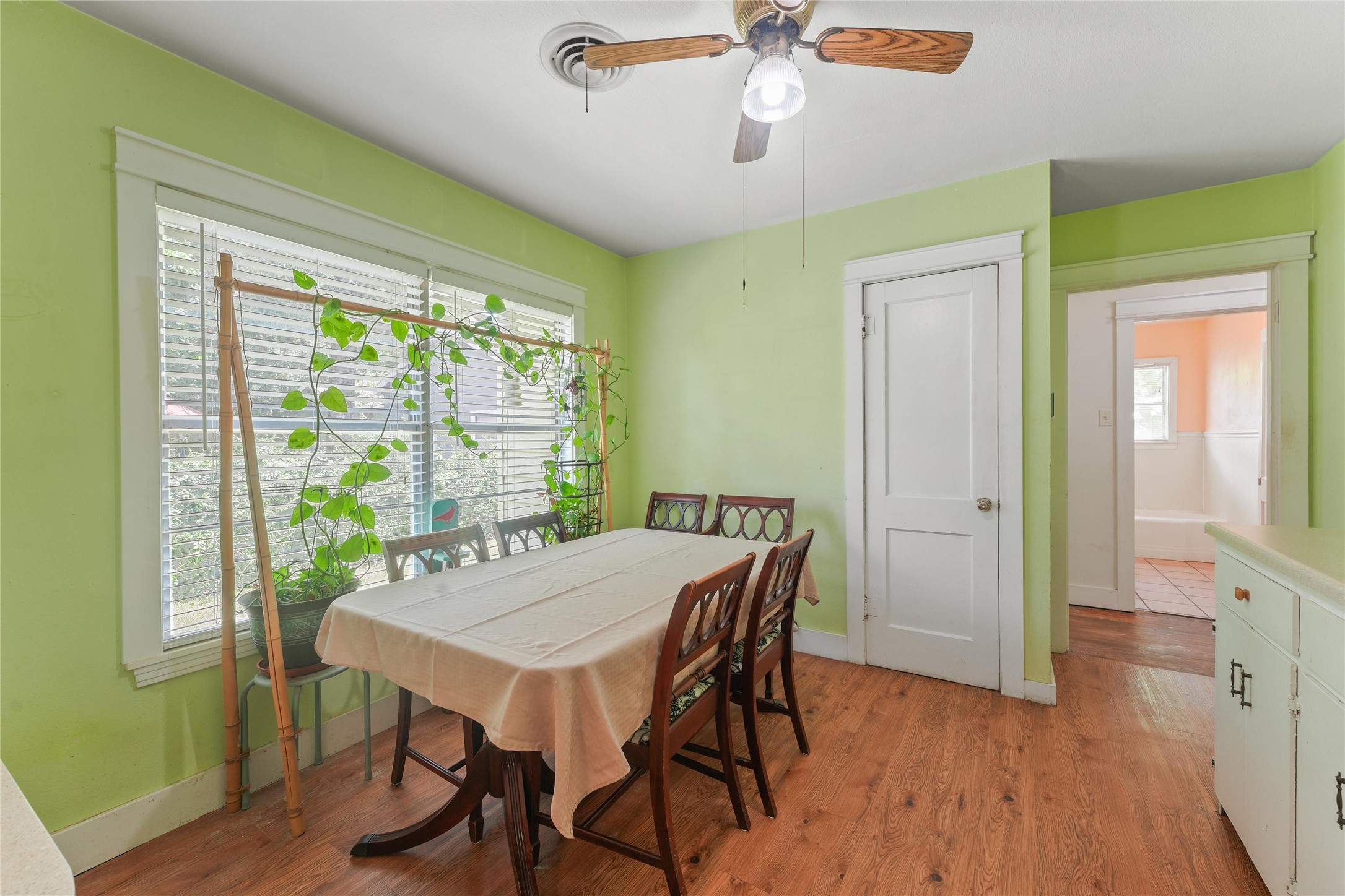 2702 Mckinney Road Baytown, TX 77520 - Photo 8 of 22 a view of a dining room with furniture window and wooden floor