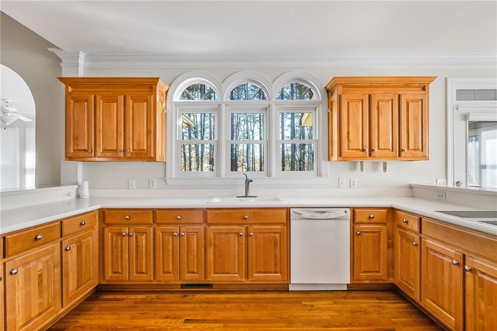2013 Cockrell Run Northwest Kennesaw, GA 30152 - Photo 19 of 69 a kitchen with stainless steel appliances granite countertop a sink and cabinets with wooden floors